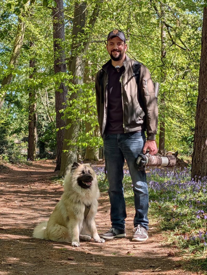 Bryn Ditheridge with his dog in a Norfolk bluebell wood, telephoto lens in hand