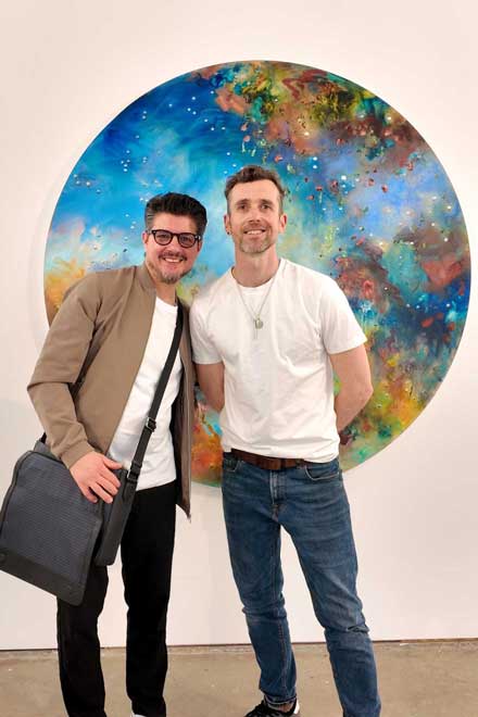 Thomas Chard with artist Chris Rivers in front of a large circular painting at Pontone Gallery, London.